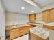 Basement bar area featuring wood cabinets, granite countertops and plenty of storage space at 2316 Weatherstone Cir, Highlands Ranch, CO 80126