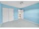 Welcoming bedroom with blue walls, a ceiling fan, and a closet at 2316 Weatherstone Cir, Highlands Ranch, CO 80126