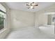 Bedroom with neutral carpet, neutral walls, ceiling fan and two windows at 2316 Weatherstone Cir, Highlands Ranch, CO 80126