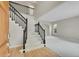 Elegant foyer featuring a staircase with black iron railings and hardwood floors at 2316 Weatherstone Cir, Highlands Ranch, CO 80126