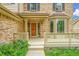 Inviting front entrance featuring a covered porch, bay window, and brick exterior at 2316 Weatherstone Cir, Highlands Ranch, CO 80126