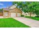Spacious two-car garage featuring a concrete driveway and landscaped front yard at 2316 Weatherstone Cir, Highlands Ranch, CO 80126