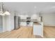 Open kitchen with white cabinetry, stainless steel appliances, granite countertops and hardwood floors at 2316 Weatherstone Cir, Highlands Ranch, CO 80126