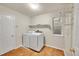 Functional laundry room with modern washer and dryer, plus ample storage shelves at 2316 Weatherstone Cir, Highlands Ranch, CO 80126