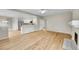 Open concept living area with stainless appliances, white cabinets and hardwood floors at 2316 Weatherstone Cir, Highlands Ranch, CO 80126