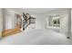 Spacious living room with archway and staircase and plenty of natural light at 2316 Weatherstone Cir, Highlands Ranch, CO 80126