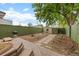 Backyard with stone pavers, a grill, and a green fence for privacy at 3055 N York St, Denver, CO 80205