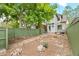 Backyard with stone pavers, a grill, a green fence for privacy, and decorative landscaping at 3055 N York St, Denver, CO 80205
