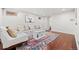 Cozy basement living area with comfortable seating, stylish rug, and ample natural light at 3055 N York St, Denver, CO 80205