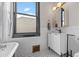 Elegant bathroom featuring a clawfoot tub, stylish vanity, and modern mirror and lighting at 3055 N York St, Denver, CO 80205