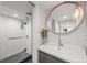 Updated bathroom with walk-in shower and sink with an accent mirror at 3055 N York St, Denver, CO 80205