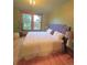 Bedroom featuring a large window, a comfortable queen-sized bed, and hardwood floors at 3055 N York St, Denver, CO 80205