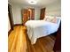Spacious bedroom featuring hardwood floors, a closet, and a queen bed at 3055 N York St, Denver, CO 80205