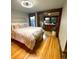 Bright bedroom with hardwood floors, a ceiling fan, and an attached office area at 3055 N York St, Denver, CO 80205