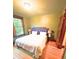 Bedroom featuring a large window, a comfortable queen-sized bed, and hardwood floors at 3055 N York St, Denver, CO 80205