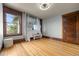 Bright bedroom featuring a large window and hardwood floors, filled with natural light at 3055 N York St, Denver, CO 80205