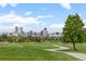 A manicured green lawn in front of a skyline view of the city at 3055 N York St, Denver, CO 80205