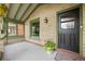 Inviting covered porch featuring exposed brick and cozy space for outdoor decor at 3055 N York St, Denver, CO 80205