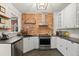 Well-lit kitchen showcasing stainless steel appliances, exposed brick wall, and modern cabinetry at 3055 N York St, Denver, CO 80205