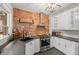 Modern kitchen featuring a brick accent wall, stainless steel appliances, and sleek countertops at 3055 N York St, Denver, CO 80205