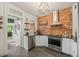 Stylish kitchen boasts stainless steel appliances, exposed brick accent wall, and contemporary lighting at 3055 N York St, Denver, CO 80205