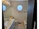 Bathroom with double vanity, round window, and bathtub at 84 S Carlton St, Castle Rock, CO 80104