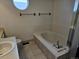 Bathroom with bathtub and shower, featuring a round window at 84 S Carlton St, Castle Rock, CO 80104