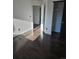 Bedroom featuring wood floors, neutral walls, and a closet with a black sliding door at 84 S Carlton St, Castle Rock, CO 80104