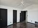 Bright bedroom with dark wood floors and multiple doors at 84 S Carlton St, Castle Rock, CO 80104