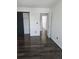 Bedroom featuring wood floors, neutral walls, and a closet with a black sliding door at 84 S Carlton St, Castle Rock, CO 80104