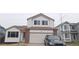 Two-story house with brick and vinyl siding, attached garage, and landscaping at 84 S Carlton St, Castle Rock, CO 80104