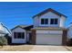 Charming two-story home featuring white siding, brick accents, and an attached two-car garage at 84 S Carlton St, Castle Rock, CO 80104