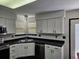 Updated kitchen featuring white cabinets and corner sink at 84 S Carlton St, Castle Rock, CO 80104