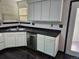 Bright kitchen with white cabinets, dark countertops, and stainless steel dishwasher at 84 S Carlton St, Castle Rock, CO 80104