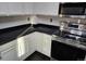 Kitchen boasts stainless steel appliances and dark countertops at 84 S Carlton St, Castle Rock, CO 80104