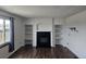 Cozy living room features a fireplace, built-in shelving, and hardwood floors at 84 S Carlton St, Castle Rock, CO 80104