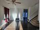 Bright living room featuring wood floors, large window, and staircase to the upper level at 84 S Carlton St, Castle Rock, CO 80104