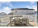 A back deck overlooking the backyard has a table and chairs at 1030 W Hopkins Dr, Elizabeth, CO 80107