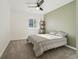 Sunlit bedroom with a large window, overhead fan and modern shelving and carpeted floors at 1030 W Hopkins Dr, Elizabeth, CO 80107