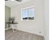 Bright bedroom featuring a gray carpet, a window, and an olive accent wall at 1030 W Hopkins Dr, Elizabeth, CO 80107