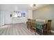 Inviting dining area with light laminate floors, modern lighting and white cabinets for entertaining at 1030 W Hopkins Dr, Elizabeth, CO 80107