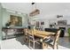 Dining room with a rustic wooden table, six chairs, and a modern light fixture at 1030 W Hopkins Dr, Elizabeth, CO 80107