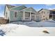 House exterior with snowy front yard and porch at 1030 W Hopkins Dr, Elizabeth, CO 80107