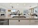 Open-concept kitchen with granite counters and a sink, adjacent to the dining and living spaces at 1030 W Hopkins Dr, Elizabeth, CO 80107