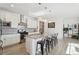 Well-lit kitchen featuring stainless steel appliances, a sizable island with bar seating, and sleek white cabinetry at 1030 W Hopkins Dr, Elizabeth, CO 80107