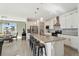 Open concept kitchen with island, white cabinets, granite countertops, and stainless steel appliances at 1030 W Hopkins Dr, Elizabeth, CO 80107