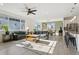 Bright living room with comfortable seating, a ceiling fan, and access to the modern kitchen and dining area at 1030 W Hopkins Dr, Elizabeth, CO 80107