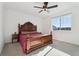 Bright primary bedroom with a ceiling fan, ample natural light and neutral colored carpet at 1030 W Hopkins Dr, Elizabeth, CO 80107