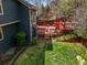 Green backyard featuring a multi-level red deck and a spacious lawn at 5723 S Everett Way, Littleton, CO 80123