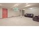 Spacious basement featuring carpet and a unique light fixture over the lounge area at 5723 S Everett Way, Littleton, CO 80123